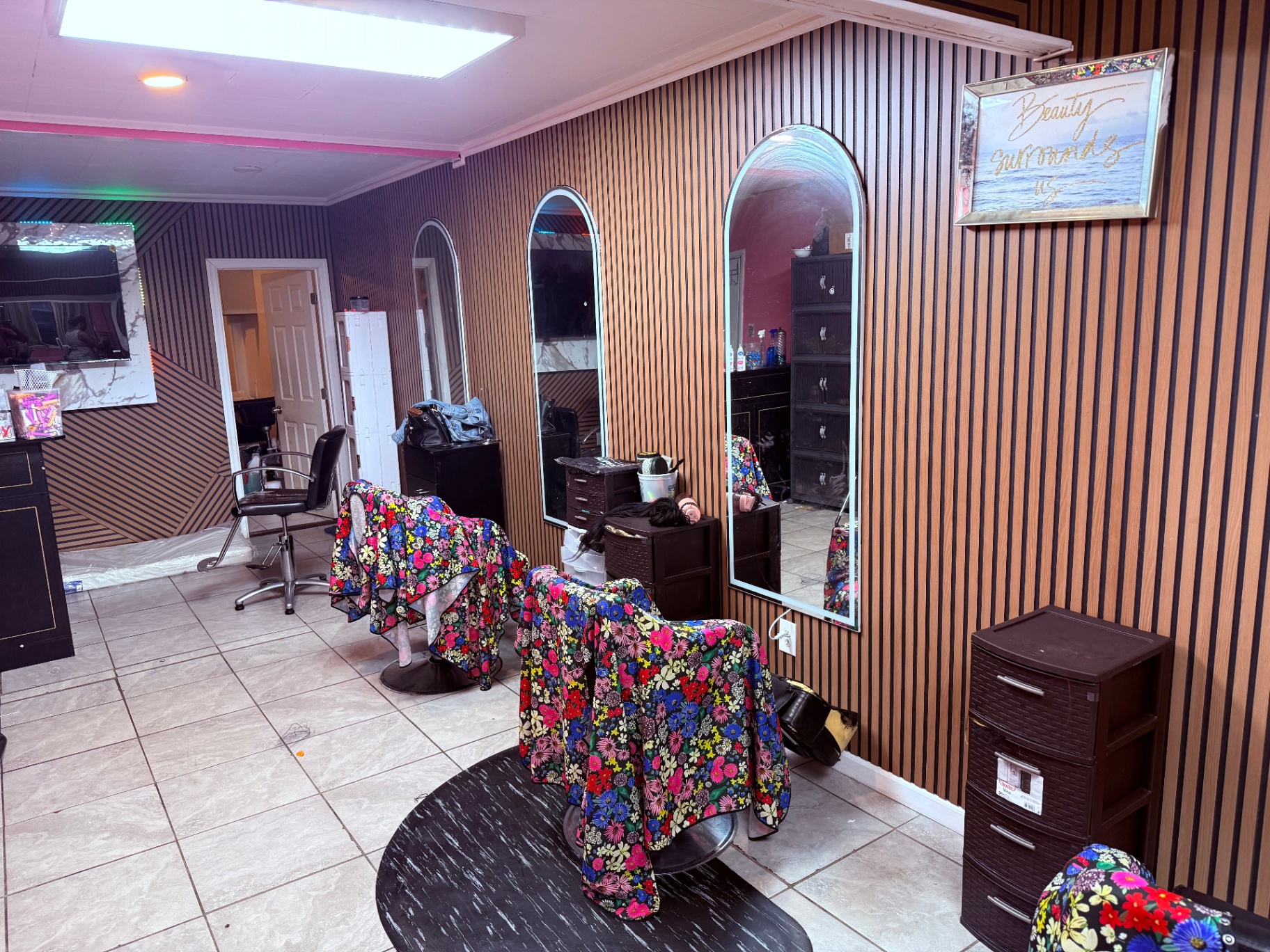 Styling stations along wood-paneled wall